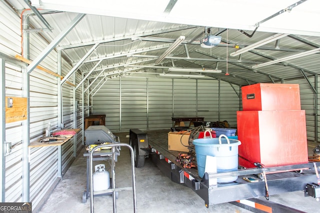 garage with a garage door opener and metal wall