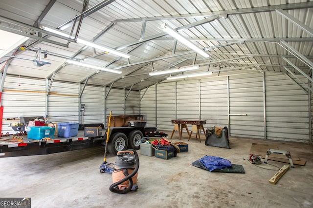 garage featuring a garage door opener and metal wall