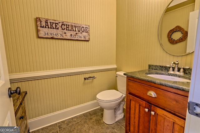 bathroom featuring vanity, tile patterned flooring, and toilet