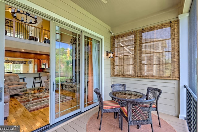 sunroom with outdoor dining space