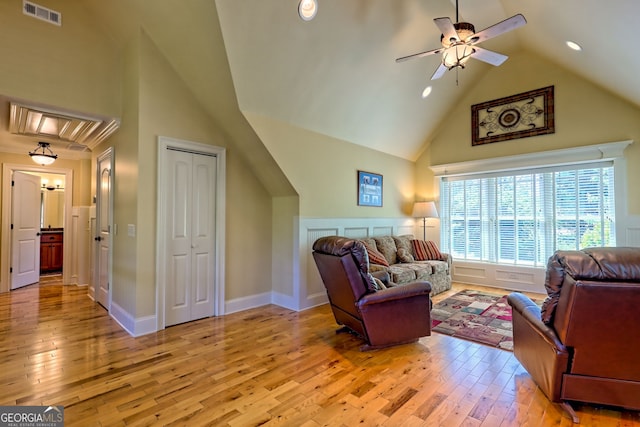 living room featuring a ceiling fan, visible vents, high vaulted ceiling, light wood-style floors, and recessed lighting