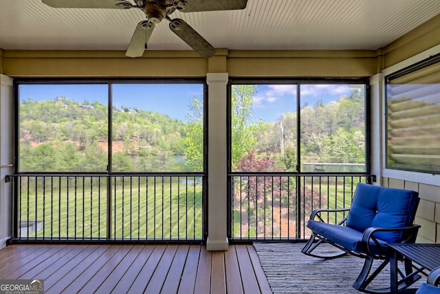 sunroom featuring ceiling fan