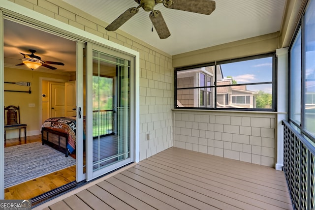 unfurnished sunroom featuring a ceiling fan