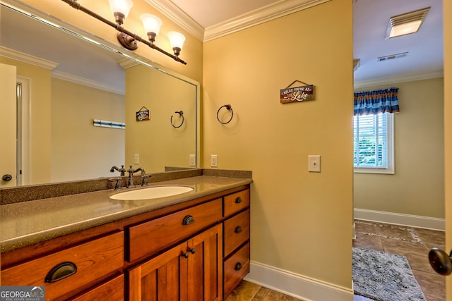 bathroom featuring crown molding, baseboards, and vanity