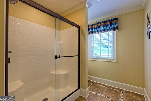 full bath featuring crown molding, baseboards, a shower stall, and tile patterned floors