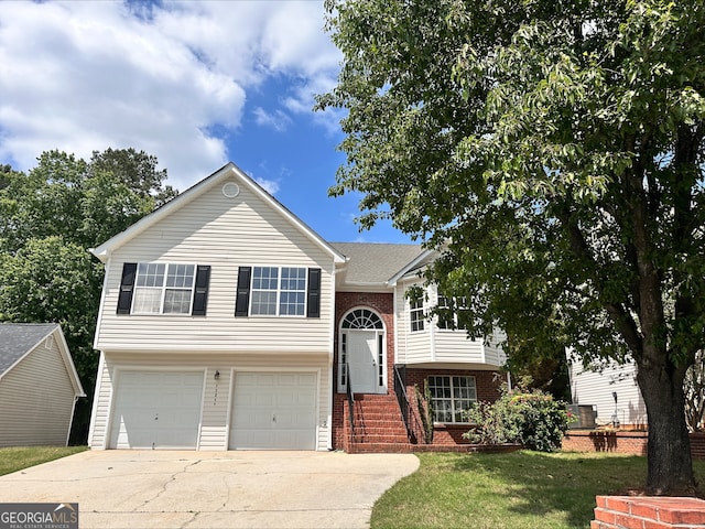 11616 Spring Lake Way, Fayetteville, GA 30215 - raised ranch with an attached garage, concrete driveway, a front lawn, and brick siding