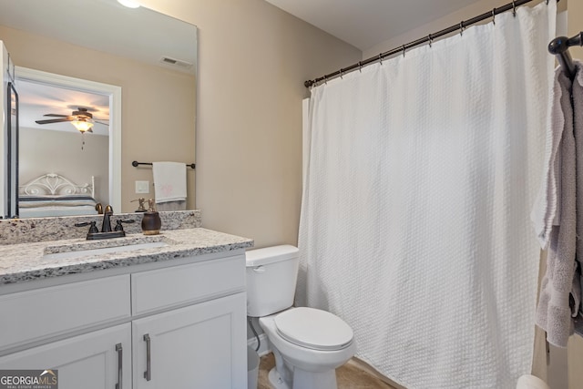 bathroom with visible vents, ceiling fan, toilet, and vanity