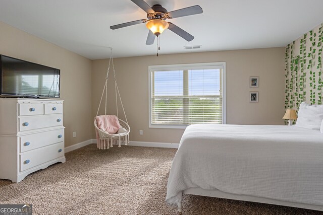 bedroom featuring visible vents, baseboards, carpet floors, and ceiling fan