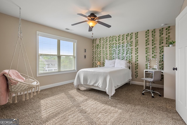 carpeted bedroom featuring baseboards, visible vents, and ceiling fan