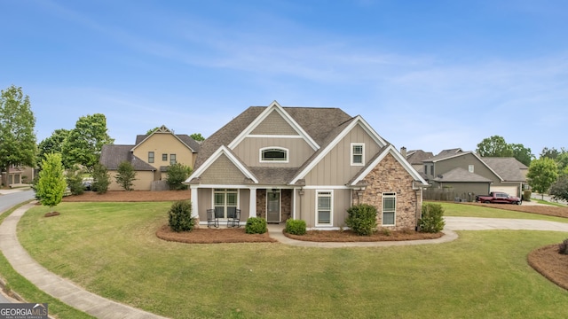 craftsman-style house with a front lawn, board and batten siding, and covered porch