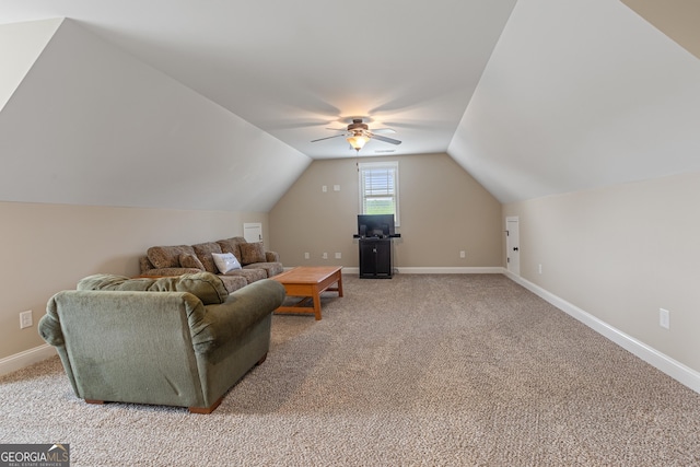 living area featuring baseboards, ceiling fan, lofted ceiling, and light carpet