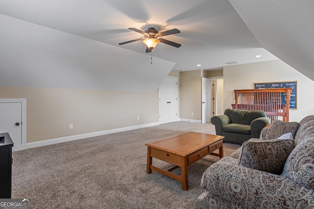 living area featuring baseboards, a ceiling fan, carpet flooring, and lofted ceiling