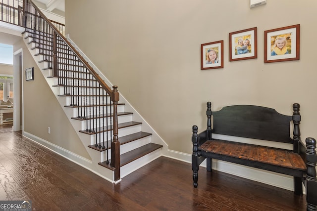 staircase featuring wood-type flooring and baseboards