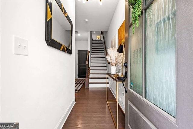 2669 Caruso Way, Atlanta, GA 30339 - hallway with baseboards, wood finished floors, and stairway