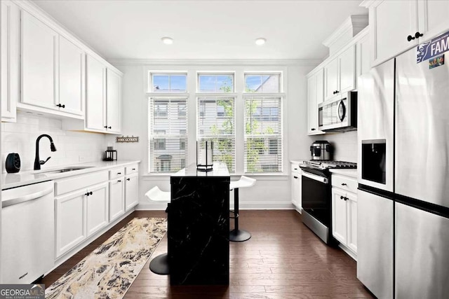 2669 Caruso Way, Atlanta, GA 30339 - kitchen featuring dark wood-style floors, appliances with stainless steel finishes, ornamental molding, and a sink