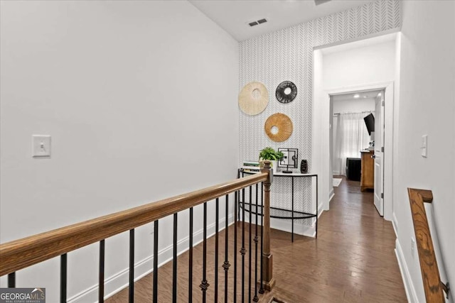 2669 Caruso Way, Atlanta, GA 30339 - hall featuring visible vents, wood finished floors, baseboards, wallpapered walls, and an upstairs landing