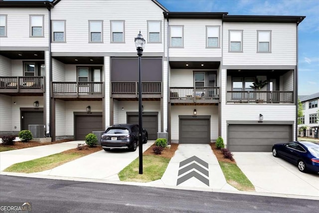 2669 Caruso Way, Atlanta, GA 30339 - view of property featuring central AC unit, an attached garage, and driveway