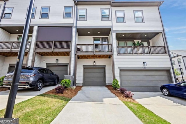 2669 Caruso Way, Atlanta, GA 30339 - view of property featuring an attached garage, driveway, and central AC