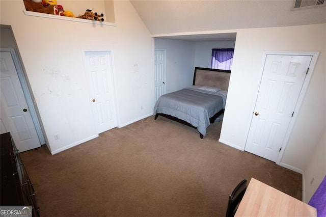 4041 Smithfield Trl, Ellenwood, GA 30294 - bedroom with visible vents, carpet, lofted ceiling, and baseboards