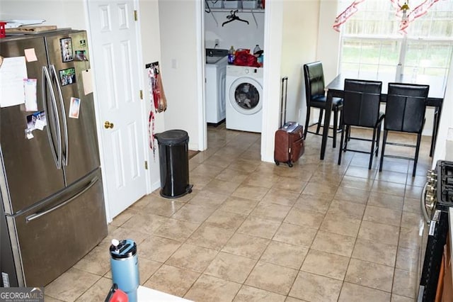 4041 Smithfield Trl, Ellenwood, GA 30294 - laundry area with light tile patterned floors and laundry area