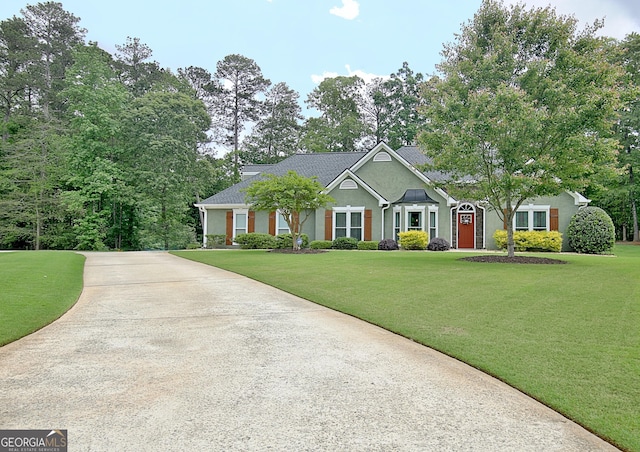 view of front of property with a front lawn, stucco siding, and driveway