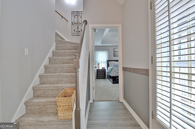 stairs featuring baseboards and wood finished floors