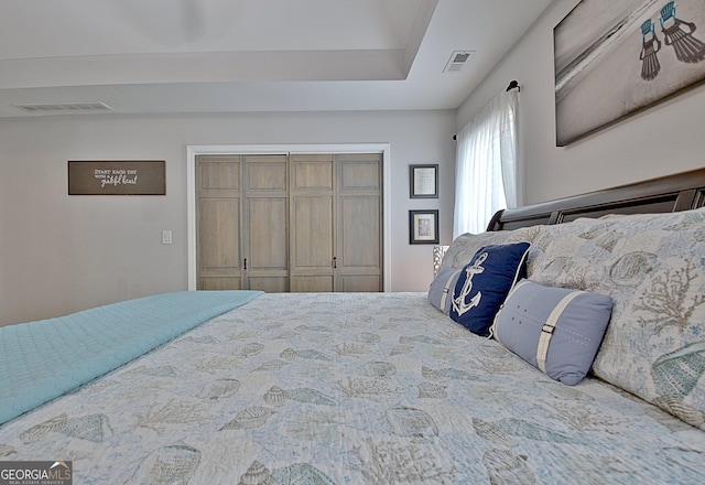 bedroom with visible vents and a closet