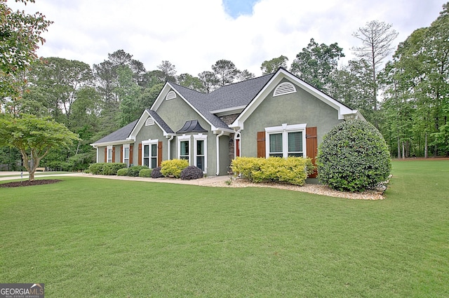 craftsman-style home with stucco siding and a front yard
