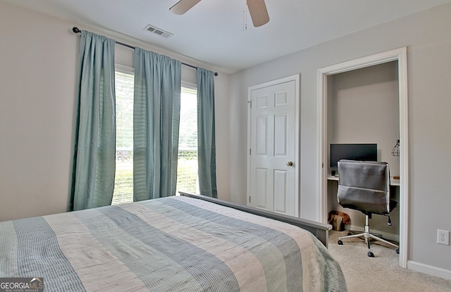 carpeted bedroom with a ceiling fan, baseboards, and visible vents