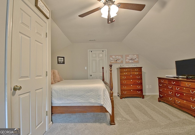 bedroom with a ceiling fan, visible vents, baseboards, lofted ceiling, and carpet