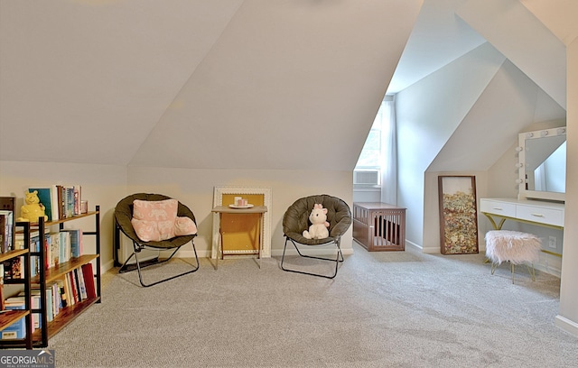 living area featuring carpet floors, baseboards, and vaulted ceiling