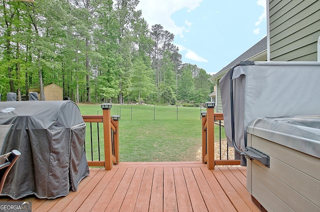 deck featuring a lawn, an outbuilding, and a shed
