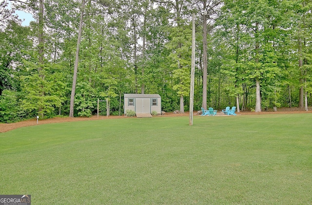 view of yard featuring a storage unit and an outbuilding