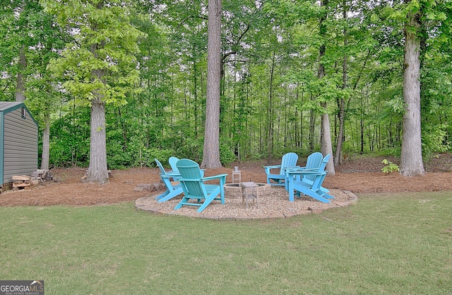 view of yard with an outdoor fire pit