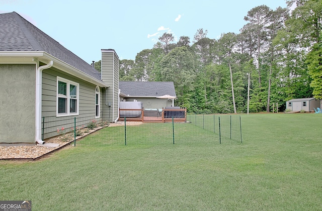 view of yard with fence and a deck