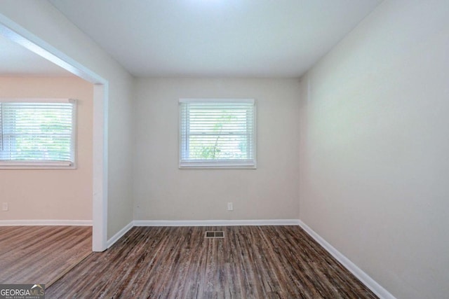 3497 Glensford Dr, Decatur, GA 30032 - empty room with plenty of natural light, baseboards, wood finished floors, and visible vents