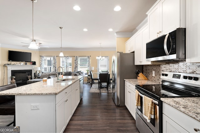 406 Crescent Woode Dr, Dallas, GA 30157 - kitchen featuring a sink, a kitchen island with sink, stainless steel appliances, open floor plan, and ornamental molding