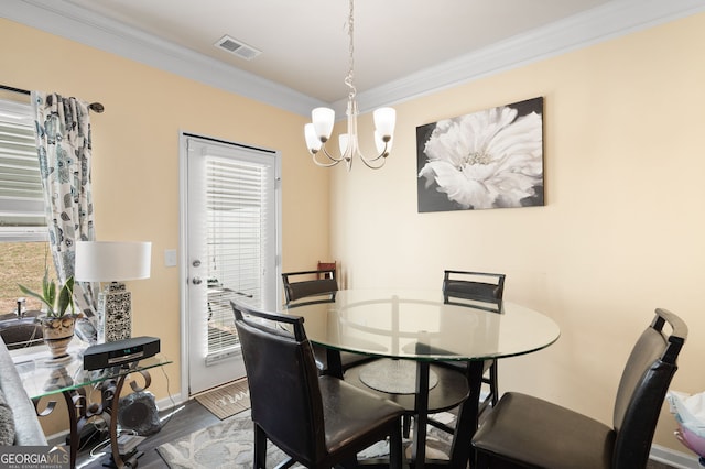 406 Crescent Woode Dr, Dallas, GA 30157 - dining space featuring visible vents, wood finished floors, baseboards, an inviting chandelier, and ornamental molding