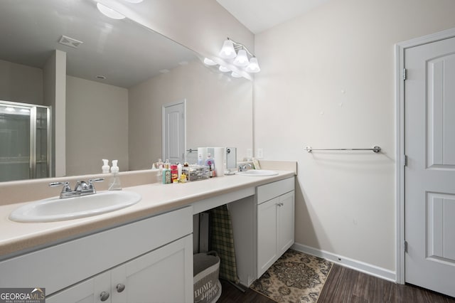 406 Crescent Woode Dr, Dallas, GA 30157 - bathroom with a sink, wood finished floors, double vanity, and visible vents
