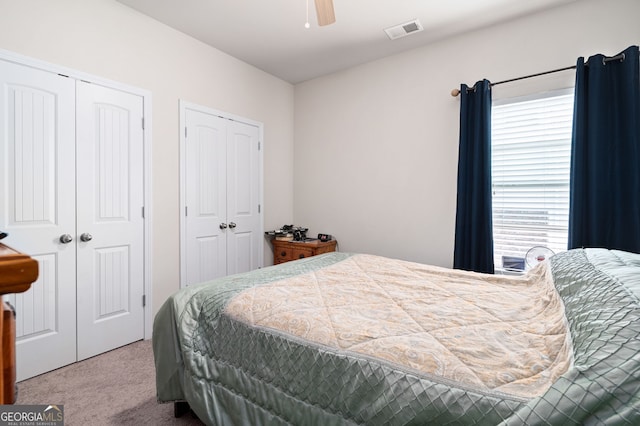 406 Crescent Woode Dr, Dallas, GA 30157 - carpeted bedroom featuring a ceiling fan, multiple closets, multiple windows, and visible vents