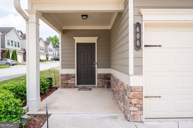 406 Crescent Woode Dr, Dallas, GA 30157 - entrance to property featuring covered porch, a residential view, stone siding, and a garage
