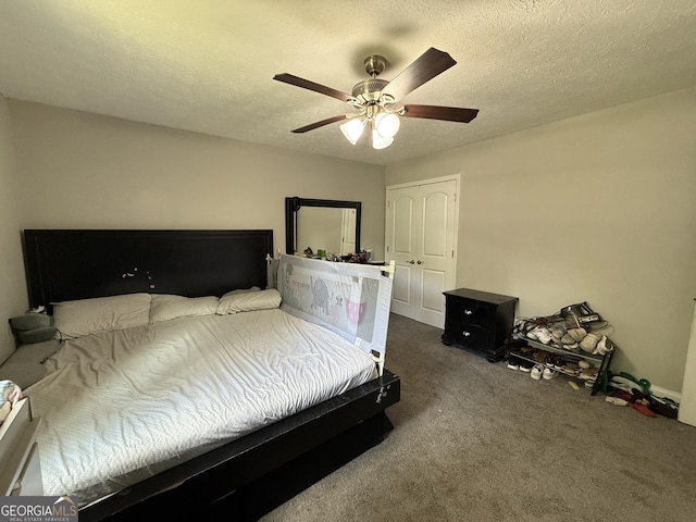 bedroom with carpet floors, a ceiling fan, and a textured ceiling