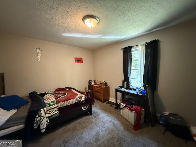 carpeted bedroom featuring a textured ceiling