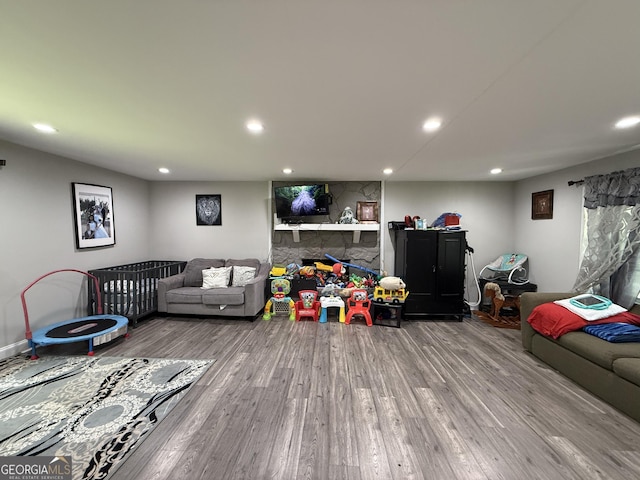 living area with recessed lighting and wood finished floors