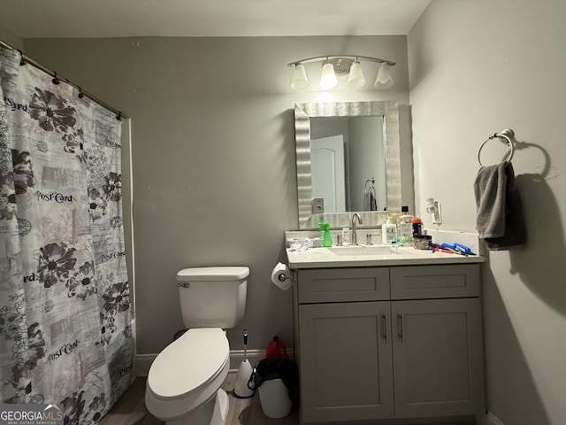 full bathroom featuring vanity, toilet, baseboards, curtained shower, and wood finished floors