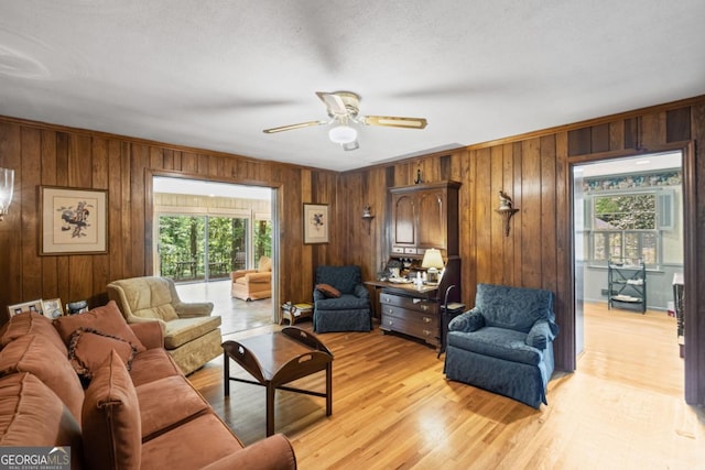 681 Hampton Pl SW, Marietta, GA 30064 - living area with crown molding, light wood-style flooring, ceiling fan, and wooden walls