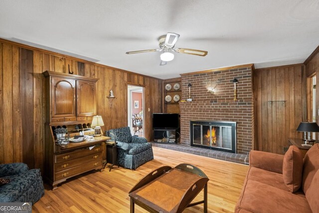 681 Hampton Pl SW, Marietta, GA 30064 - living area with light wood-style floors, wood walls, a brick fireplace, and ceiling fan