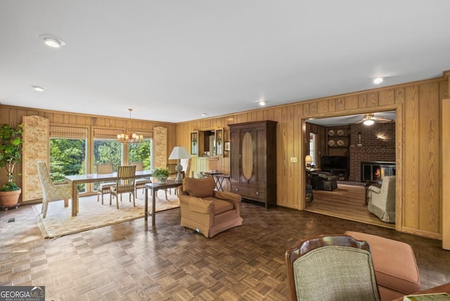 681 Hampton Pl SW, Marietta, GA 30064 - living room featuring wooden walls, a brick fireplace, recessed lighting, and a notable chandelier
