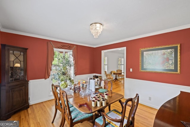 681 Hampton Pl SW, Marietta, GA 30064 - dining space with ornamental molding, light wood-style flooring, and a wainscoted wall