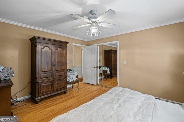 681 Hampton Pl SW, Marietta, GA 30064 - bedroom with a ceiling fan, ornamental molding, and light wood-style flooring